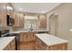 Lovely kitchen featuring light wood cabinetry, island, and stainless appliances at 10249 Trailriders Dr, Littleton, CO 80125