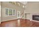 Well-lit living room with hardwood floors, a fireplace, and access to the backyard at 10249 Trailriders Dr, Littleton, CO 80125