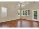 Bright and airy living room featuring hardwood floors, high ceilings, and natural light at 10249 Trailriders Dr, Littleton, CO 80125