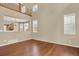 Open living space with hardwood floors, large windows, and a view of the upper level at 10249 Trailriders Dr, Littleton, CO 80125