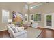 Spacious living room with vaulted ceilings, large windows, and stylish hardwood flooring at 10249 Trailriders Dr, Littleton, CO 80125