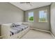 This well lit bedroom features neutral colors, a daybed and dual windows at 15886 E Stargazer Ln, Parker, CO 80134