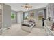 This modern bedroom features neutral colors, a fan and view of the neighborhood at 15886 E Stargazer Ln, Parker, CO 80134