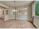 Hardwood floored dining room illuminated by large window and showcasing open-concept layout at 15886 E Stargazer Ln, Parker, CO 80134