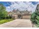 Attractive two-story home featuring a three-car garage, well-maintained lawn, and beautiful landscaping at 15886 E Stargazer Ln, Parker, CO 80134