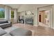 Comfortable living room features a fireplace, TV, and a view into the bathroom at 15886 E Stargazer Ln, Parker, CO 80134