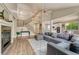 Open concept living room with fireplace, staircase, and adjoins kitchen and dining area at 15886 E Stargazer Ln, Parker, CO 80134