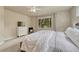 The main bedroom has neutral decor, a large window and adjacent tv at 15886 E Stargazer Ln, Parker, CO 80134