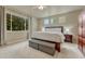 This main bedroom features neutral colors, a large window and a king sized bed at 15886 E Stargazer Ln, Parker, CO 80134