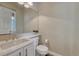 Cozy powder room features a marble vanity, toilet and a decorative mirror at 15886 E Stargazer Ln, Parker, CO 80134