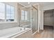 Bathroom features a soaking tub, glass-enclosed shower, and tiled walls for a sleek design at 39152 Clymer St, Elizabeth, CO 80107