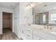 Bathroom vanity featuring double sinks, modern fixtures, and access to the walk-in shower and closet at 39152 Clymer St, Elizabeth, CO 80107