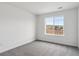 Comfortable bedroom featuring a large window with views of the fence and lush surrounding landscape at 39152 Clymer St, Elizabeth, CO 80107