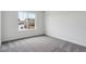 Bright bedroom with gray carpet and a large window offering neighborhood views at 39152 Clymer St, Elizabeth, CO 80107