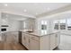 Well-designed kitchen with a large island, modern faucet, and seamless transition to the living spaces at 39152 Clymer St, Elizabeth, CO 80107