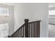 Staircase features dark wood railings and trim, with bright lighting from nearby windows at 39152 Clymer St, Elizabeth, CO 80107
