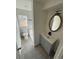 Modern bathroom with stylish gray vanity and updated fixtures at 9036 Mandel St, Denver, CO 80260