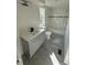 Modern bathroom featuring a gray vanity, updated fixtures, and gray tile flooring at 9036 Mandel St, Denver, CO 80260