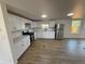 Modern kitchen features white cabinets, stainless steel appliances, and sleek countertops at 9036 Mandel St, Denver, CO 80260