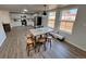 Bright kitchen features white cabinets, stainless steel appliances, and a table with four wood chairs at 9036 Mandel St, Denver, CO 80260