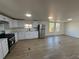 Bright and airy kitchen featuring modern appliances, white cabinets, and beautiful flooring at 9036 Mandel St, Denver, CO 80260