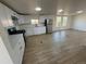 Modern kitchen with white cabinets, stainless steel appliances, and ample counter space at 9036 Mandel St, Denver, CO 80260