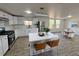 This bright, modern kitchen features white cabinets, an island, and stainless steel appliances at 9036 Mandel St, Denver, CO 80260