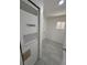This laundry room features tile flooring, a window, and hookups for a washer and dryer at 9036 Mandel St, Denver, CO 80260