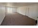 Spacious living room with new carpet and sliding glass door at 9036 Mandel St, Denver, CO 80260