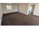 The spacious living room boasts plush carpeting and a bright, airy atmosphere with a window at 9036 Mandel St, Denver, CO 80260