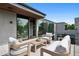 Relaxing outdoor balcony with comfortable seating, a coffee table, and a view of lush greenery at 2539 E 5Th Ave, Denver, CO 80206