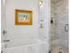 Luxurious marble bathroom with a soaking tub, a separate shower, and elegant fixtures for a spa-like experience at 2539 E 5Th Ave, Denver, CO 80206