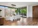 Elegant dining room featuring floor-to-ceiling windows and glass table with modern seating, merging indoor/outdoor spaces at 2539 E 5Th Ave, Denver, CO 80206