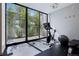 Bright home gym with large windows offering outdoor views, featuring a stationary bike and free weights at 2539 E 5Th Ave, Denver, CO 80206