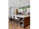 Kitchen island with seating and hardwood floors at 2539 E 5Th Ave, Denver, CO 80206