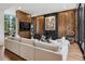 Inviting living room with wood paneling, sleek fireplace, and comfortable sectional sofa at 2539 E 5Th Ave, Denver, CO 80206