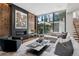 Modern living room with wood accents, fireplace, comfortable seating, and view to the outside at 2539 E 5Th Ave, Denver, CO 80206
