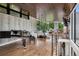 Spacious living room with hardwood floors, a grand piano, and large windows offering panoramic views at 2539 E 5Th Ave, Denver, CO 80206