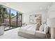 Bright main bedroom with a large window, a calming color scheme, and an artistic painting on the wall at 2539 E 5Th Ave, Denver, CO 80206