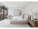 Bright main bedroom with a large window, a calming color scheme, and an artistic painting on the wall at 2539 E 5Th Ave, Denver, CO 80206