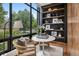 Bright office space with a round table, cozy chairs, and natural light from the large window at 2539 E 5Th Ave, Denver, CO 80206