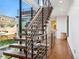 Stylish wood and metal staircase with large windows offering natural light and views of the outdoors at 2539 E 5Th Ave, Denver, CO 80206