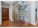Elegant, glass-enclosed wine cellar showcasing an extensive collection, hardwood floors, and display cabinet at 2539 E 5Th Ave, Denver, CO 80206