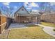 Brick home featuring a covered patio and a well-maintained lawn, perfect for outdoor enjoyment at 1355 Hudson St, Denver, CO 80220