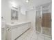 Well lit bathroom with glass shower and a long vanity with white cabinets at 1355 Hudson St, Denver, CO 80220