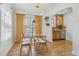 Charming dining area with a glass table, bright curtains, and views of the kitchen at 1355 Hudson St, Denver, CO 80220