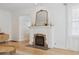 Close-up of the living room fireplace with a decorative mantle and hearth at 1355 Hudson St, Denver, CO 80220
