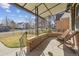 Cozy covered front porch with brick accents, offering an inviting outdoor seating area at 1355 Hudson St, Denver, CO 80220