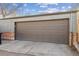 A large garage door framed by brick and shingle siding is shown at 1355 Hudson St, Denver, CO 80220