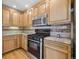 Well-appointed kitchen features stainless steel appliances, granite countertops, and wooden cabinets at 1355 Hudson St, Denver, CO 80220
